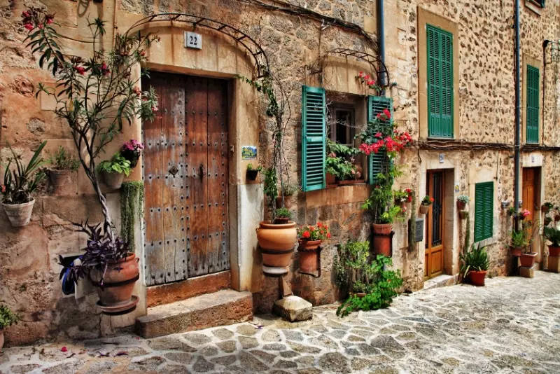 Valldemossa - one of the prettiest Mallorca towns with stone townhouses, green shutters and fresh plants