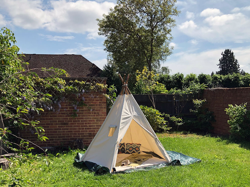 adult teepee in sunny garden