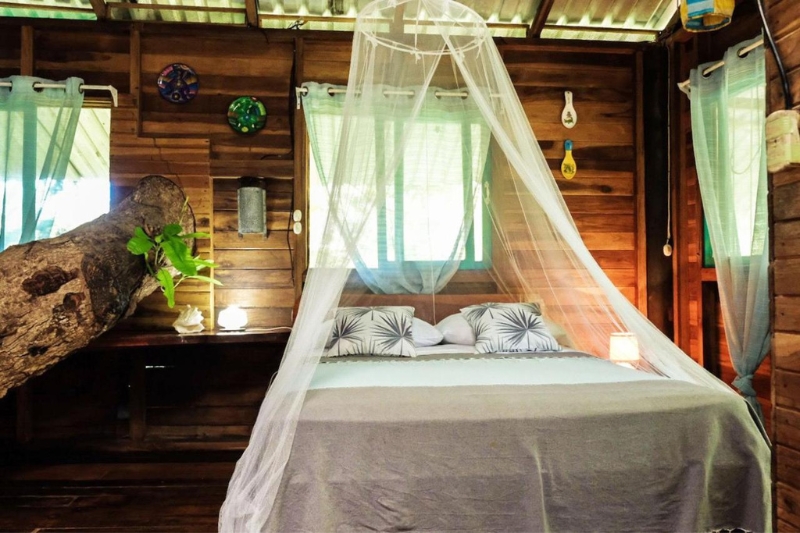 A mosquito net protects a double bed in the Playa Grande Lodge, Guanacaste